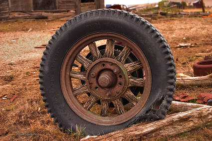 An old wooden-spoked truck tire