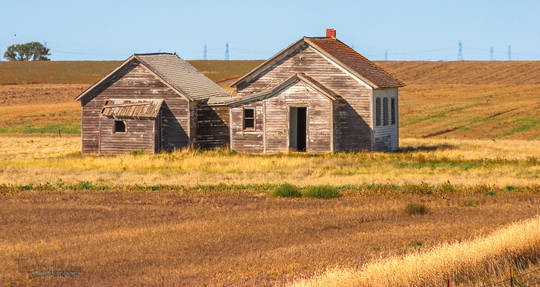 A pair of houses on the South Dakota plains.