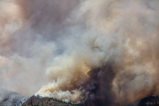 Billowing Smoke Column and Plane