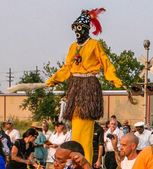 the costumed man on stilts