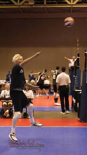 a seventy five year old player returns the volleyball